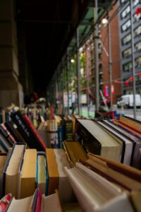 A diverse collection of books displayed outside a New York City bookshop, inviting readers.